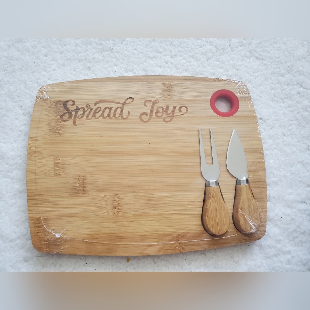 NWOT Organic Bamboo Charcuterie Board with wonderful message “Spread Joy”.
